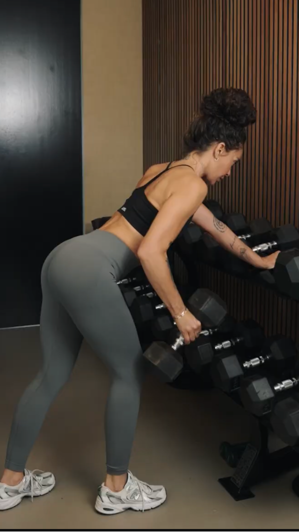 a woman lifting weights in a gym